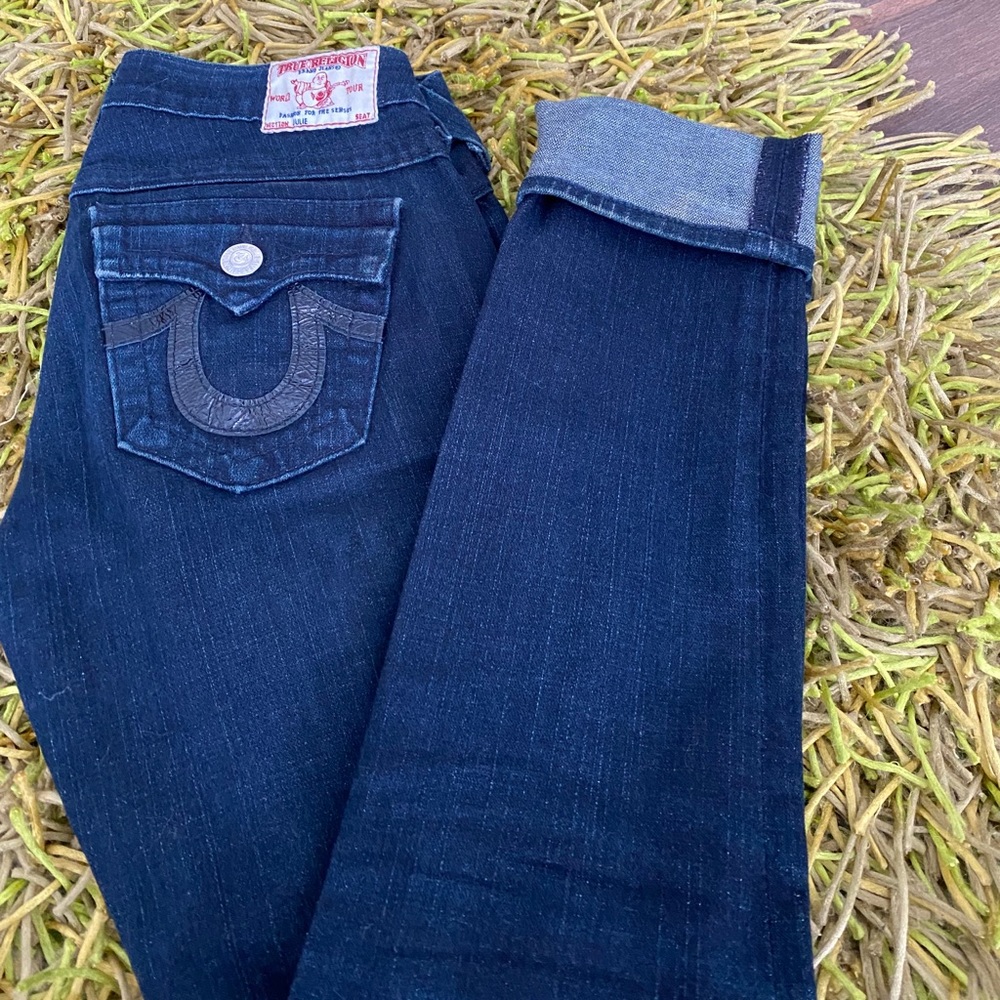 Women’s dark wash navy True Religion jeans.